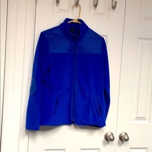 Blue jacket with quilted yoke and elbow patches.